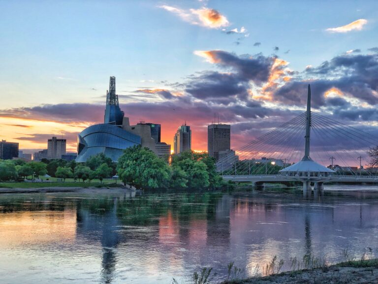 The cityscape of Winnipeg from across the river at sunset.